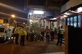 Police and patrons stand outside the Northbridge Hotel.