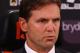 A coach at a press conference after a match. 