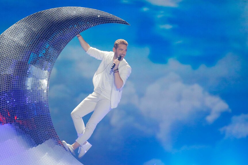 Austria's Nathan Trent took to a mirror-ball disco moon during his performance of Running on Air.