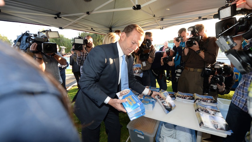 Tony Abbott hands out election pamphlets