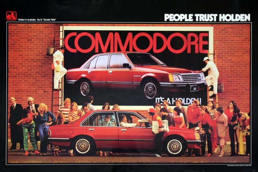 A Holden advertising poster featuring a red Commodore.