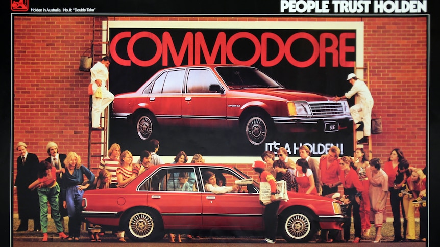 A Holden advertising poster featuring a red Commodore.