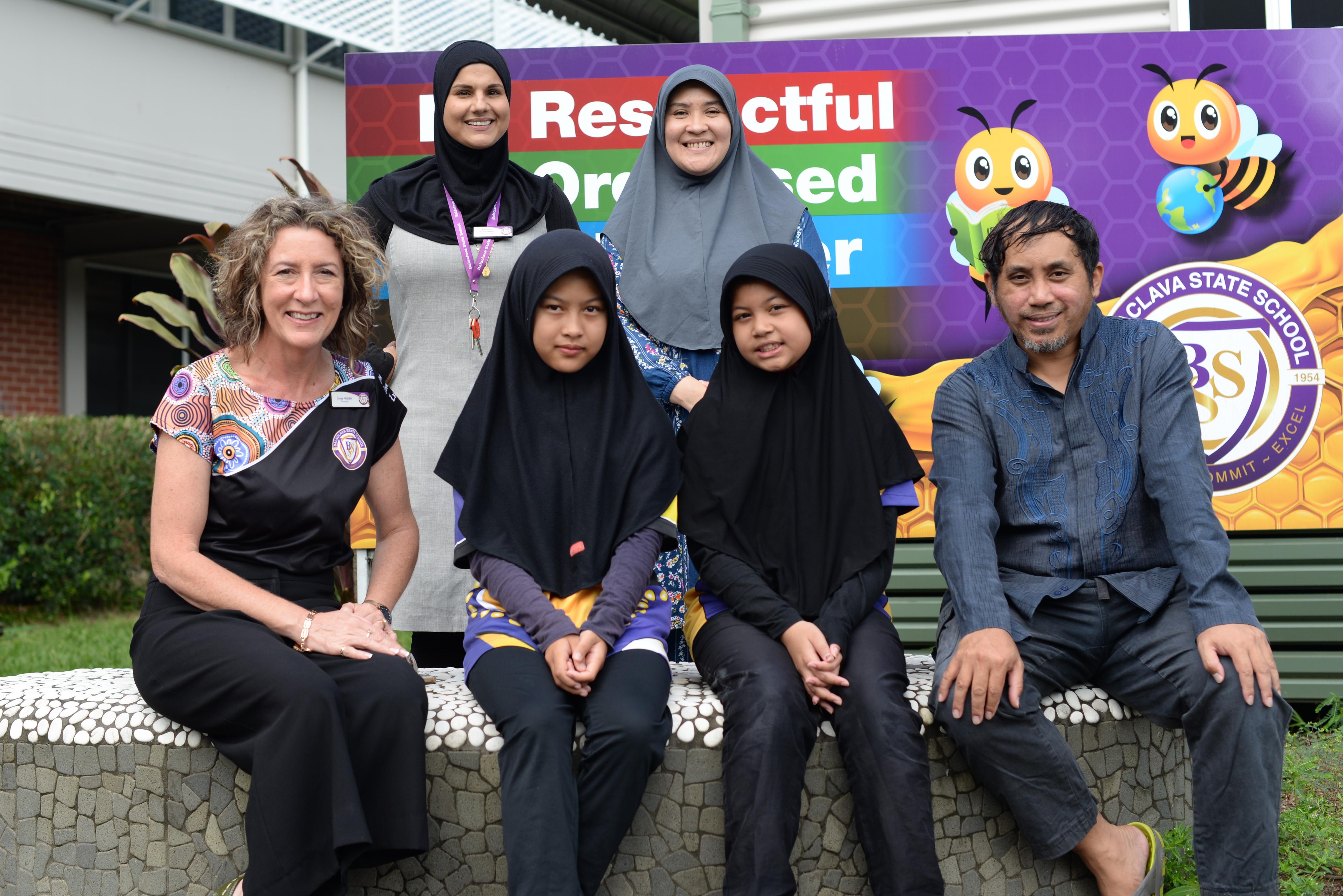 Members of the Balaclava State School community pose for a photograph in front of the school's signs.
