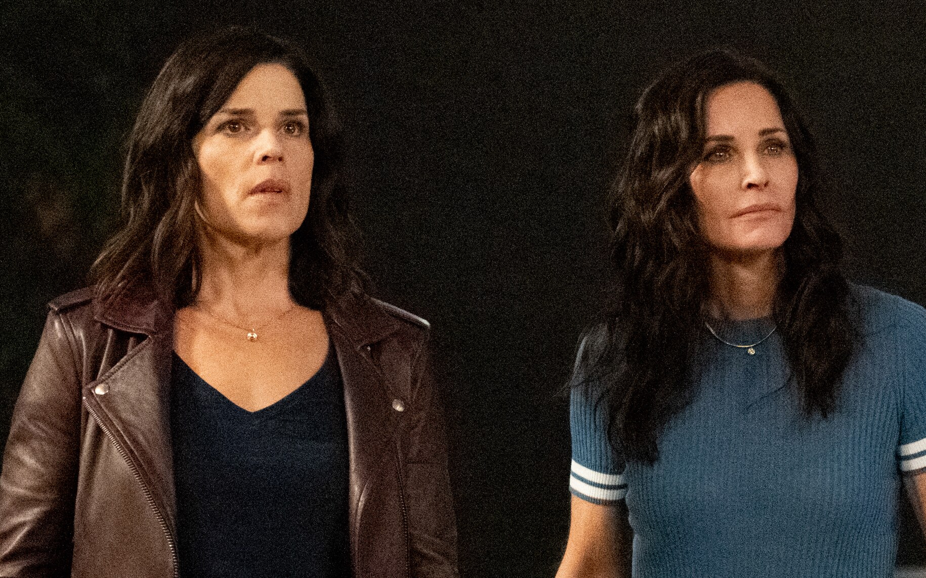Two middle-aged women with dark hair appear distressed as they look at something offscreen