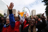 Protesters march with their hands raised at a rally in St. Louis, Missouri, October 11, 2014.