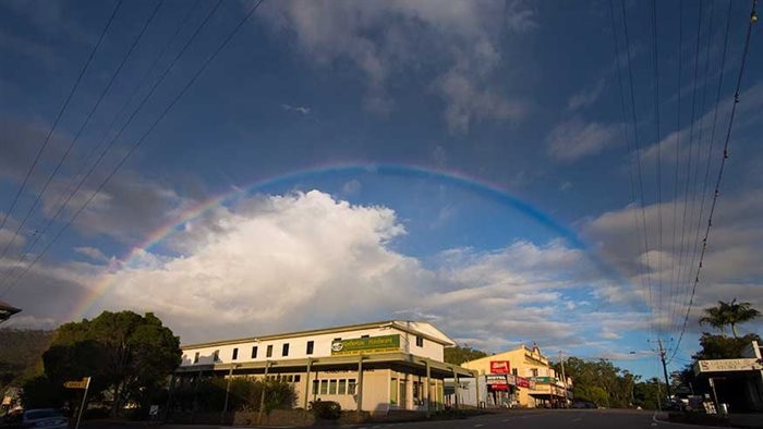 A photo of the main street of Herberton with a rainbow in the sky