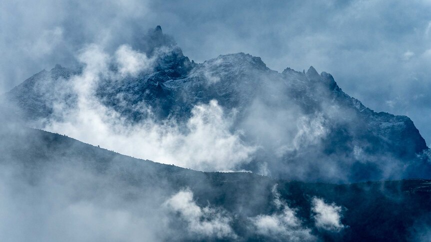 Dark mountains with craggy peaks.