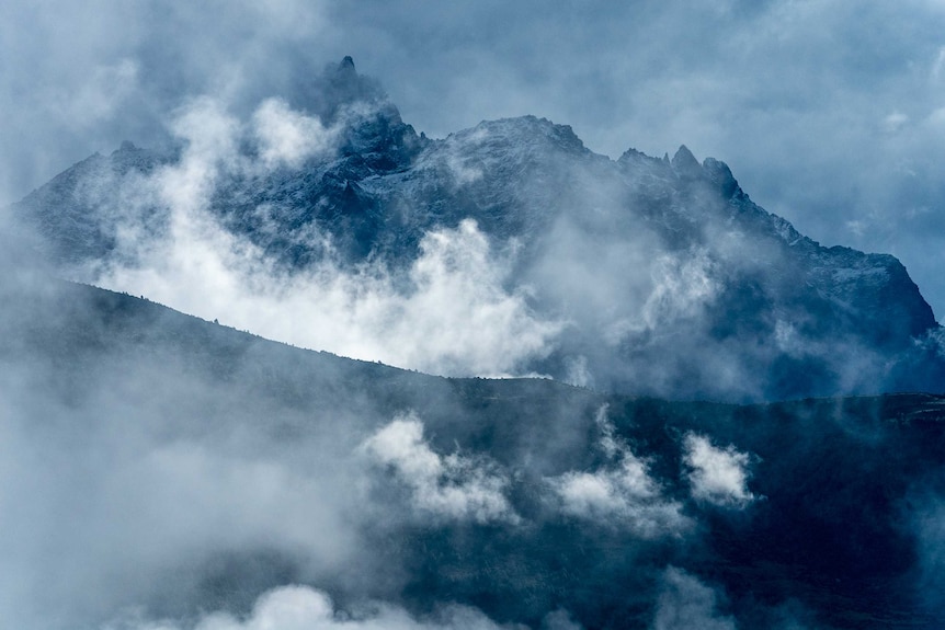 Dark mountains with craggy peaks.