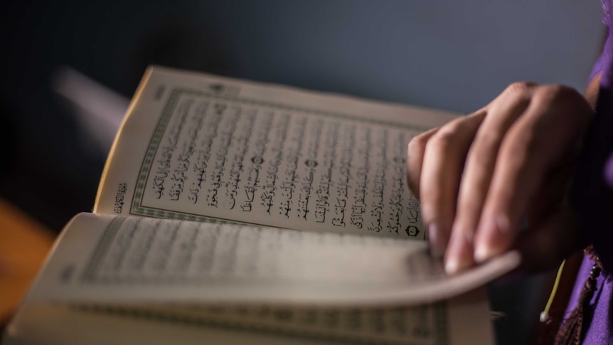 A Muslim woman reads the Qur'an