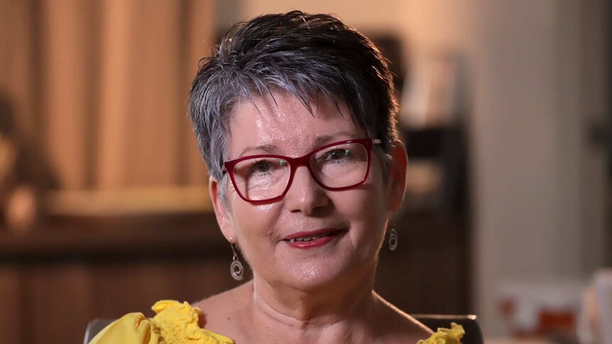 Wendy Walters wears glasses and a yellow top