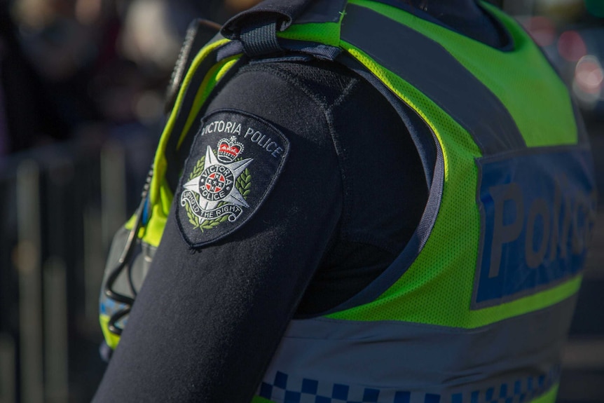 The Victoria Police crest on an officer's uniform.