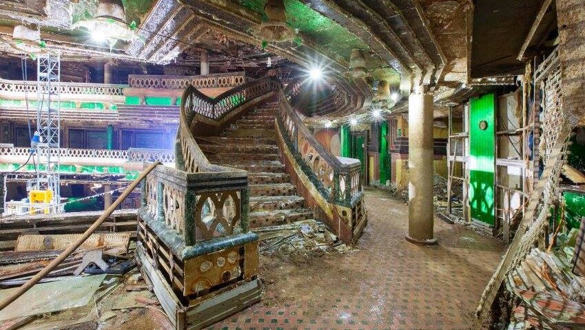 Water-damaged staircase, with debris strewn everywhere.