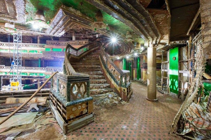 Water-damaged staircase, with debris strewn everywhere.