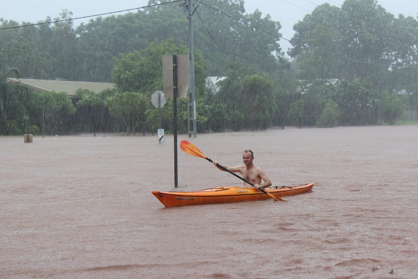 Man paddles down flooded Kununurra street