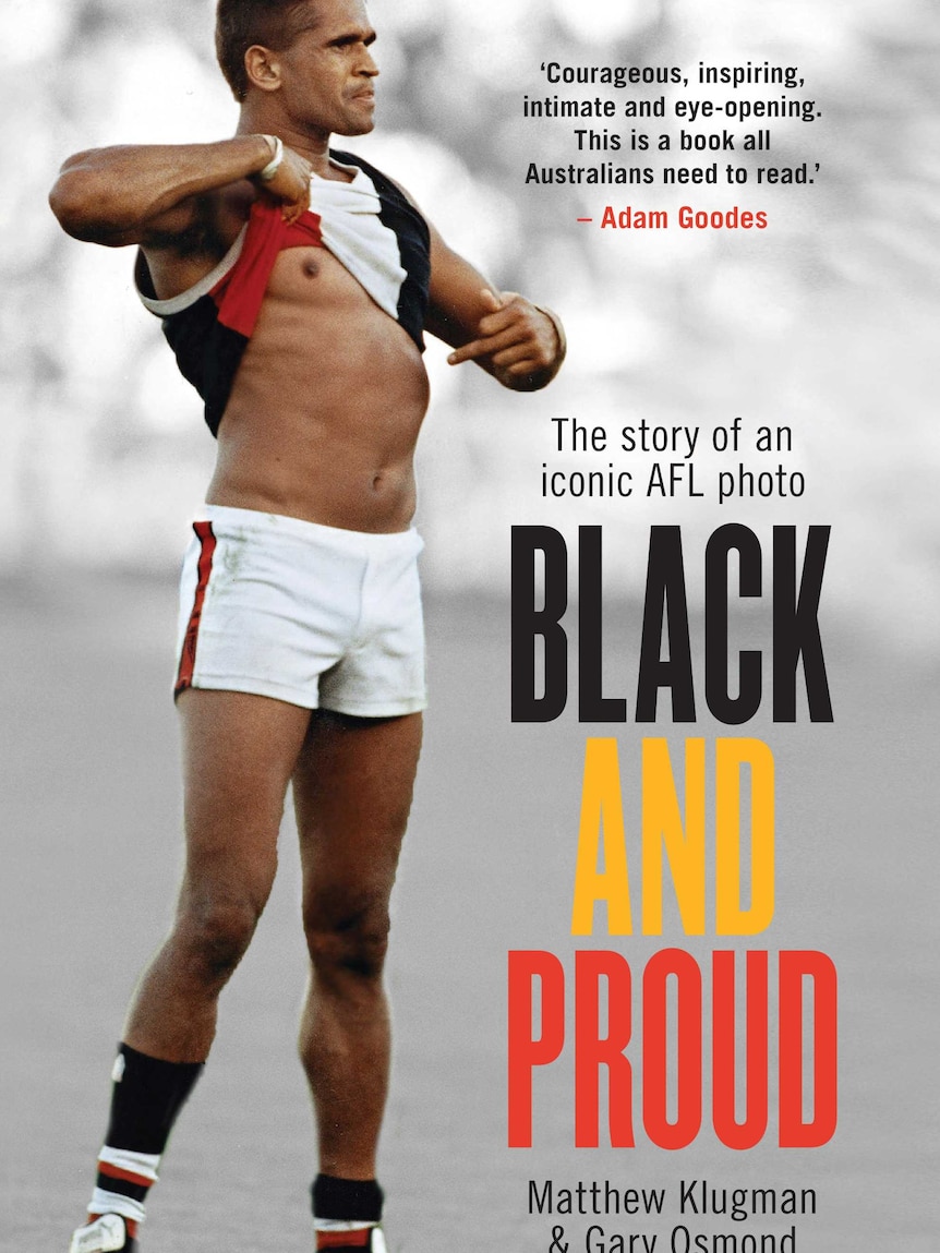 Book cover of Black and Proud by Gary Osmond and Matthew Klugman featuring Nicky Winmar pointing