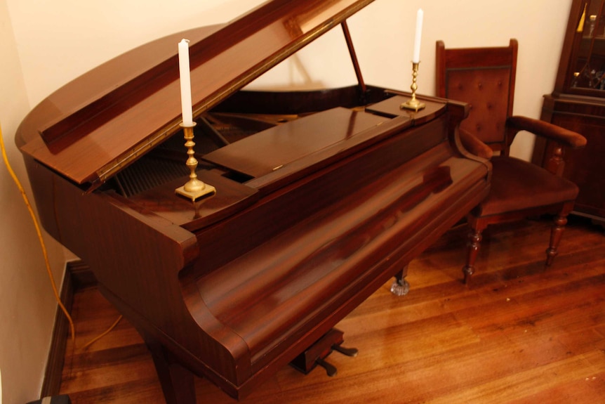 A piano with two candles