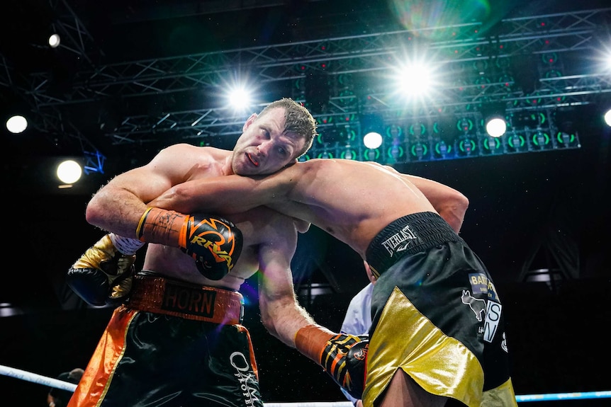 Jeff Horn (left) fights back against Tim Tszyu.