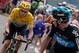 Second placed in the overall standings, Christopher Froome looks at overall leader's yellow jersey, Bradley Wiggins.