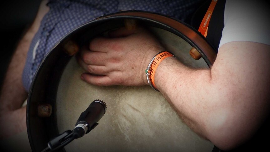 Frank McGuire playing the bodhran on The Music Show on Stage 7 at WOMADelaide 2013