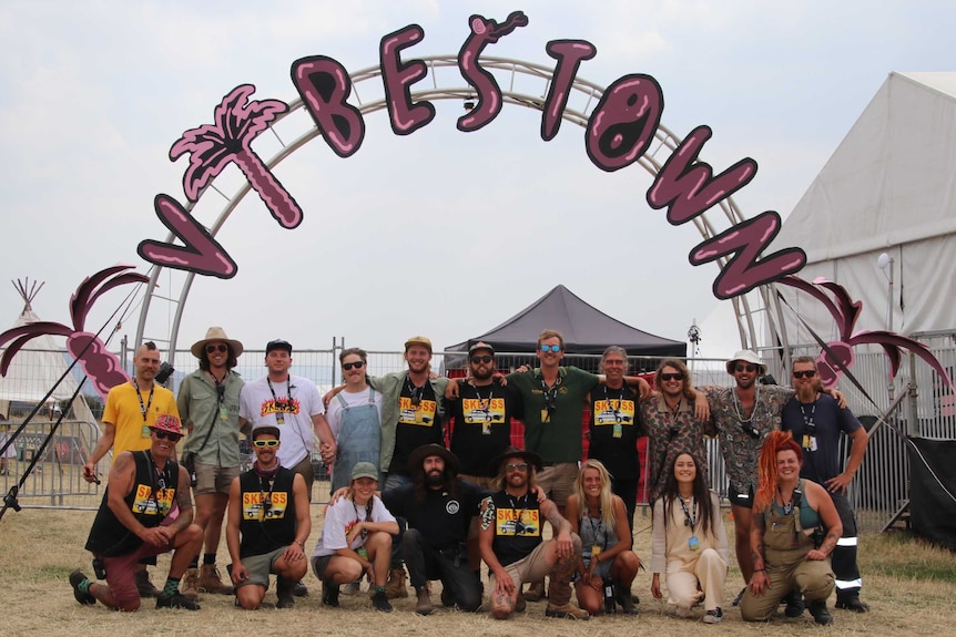 The Party in the Paddock organising committee standing under the Vibestown Productions sign