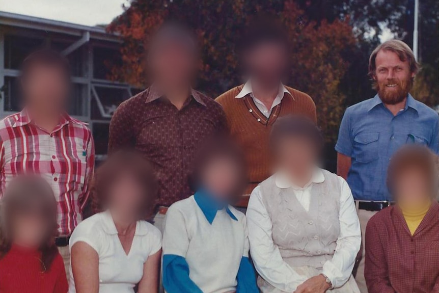 A colour photo of the staff of Bandiana Primary School. The faces of all but one man are blurred.