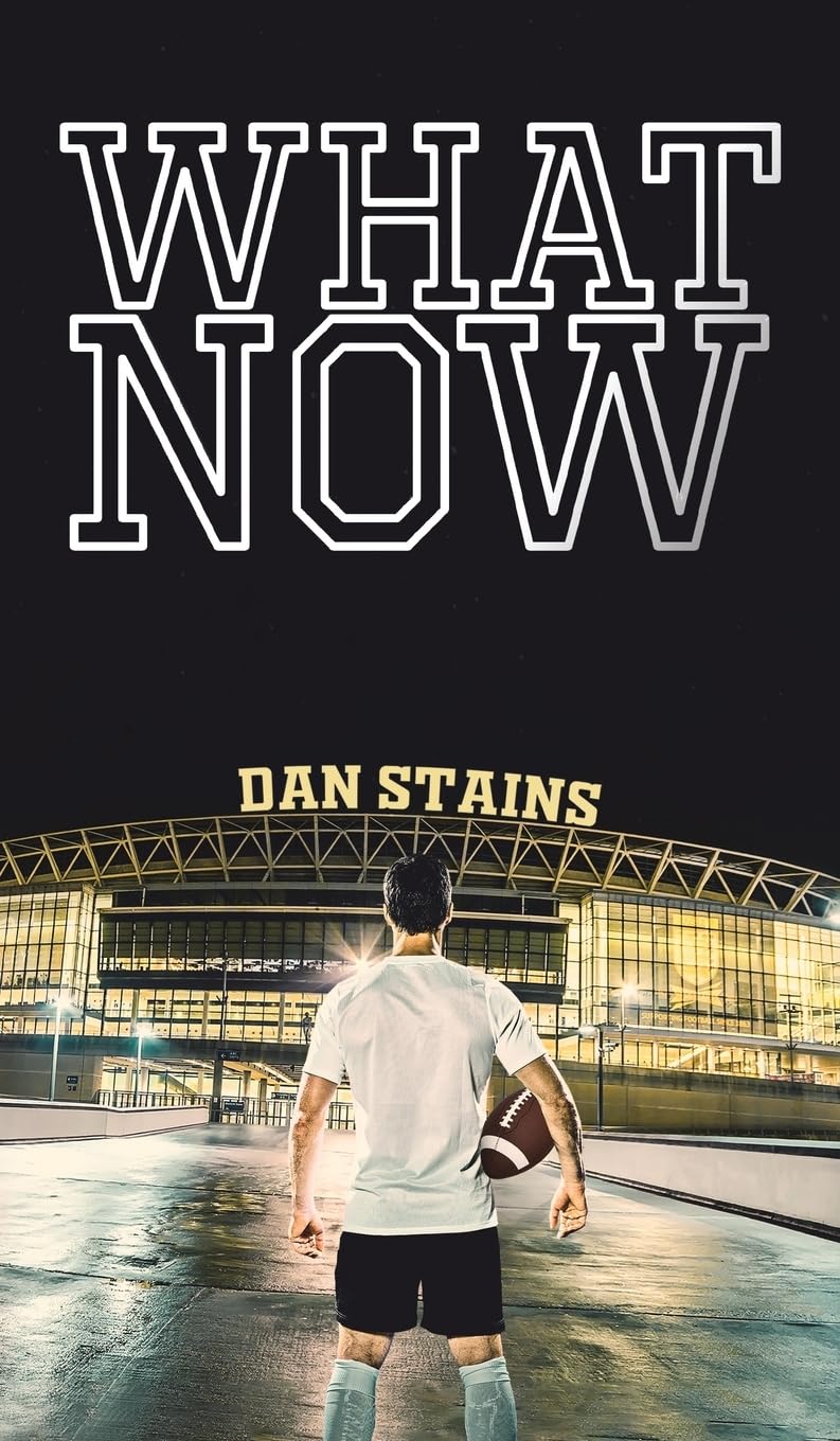 The cover of the book, What Now has Dan Stains standing looking towards a rugby league field under lights.