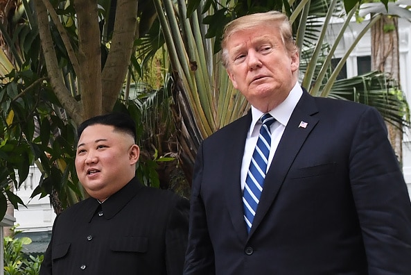 President Jump and Kim Jong Un walk next to each other.