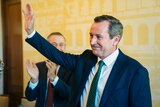 A mid shot of Mark McGowan acknowledging applause during a party meeting.