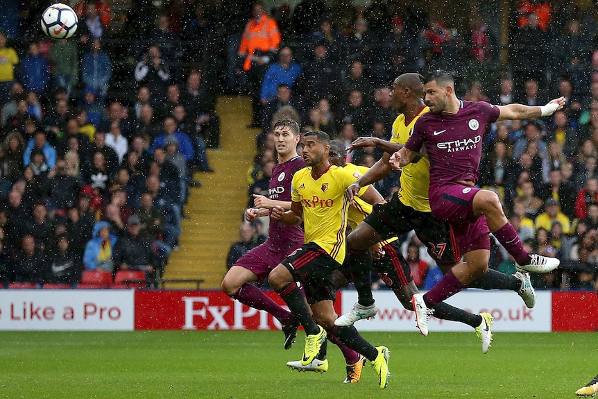Manchester City's Sergio Aguero heads in a goal against Watford