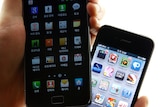 An Apple iPhone 4 smartphone and a Samsung Electronics Galaxy S II