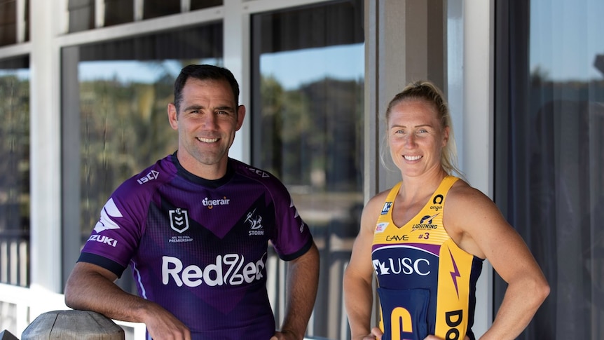 both players wear their respective kits (Storm mostly purple), Lightning (mostly yellow with purple) with hands on hips 
