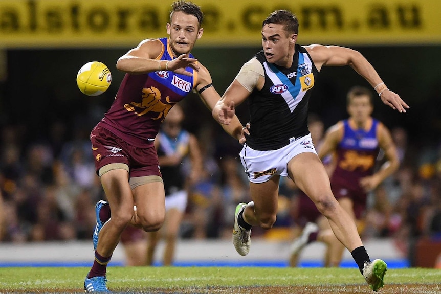 Brisbane's James Aish competes with Port Adelaide's Karl Amon at the Gabba on May 17, 2015.