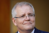Scott Morrison looks to the distance as he stands in a courtyard