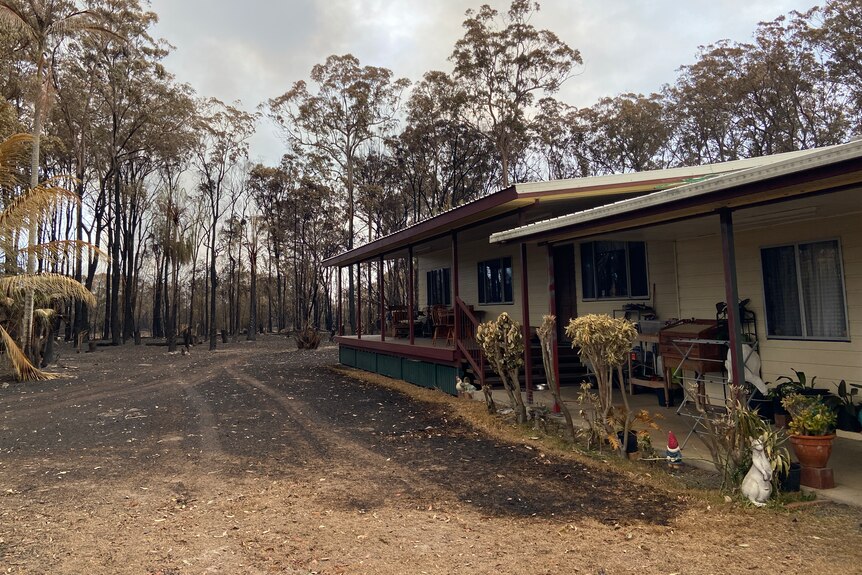 A house on the right with scorched ground less than a metre from the house