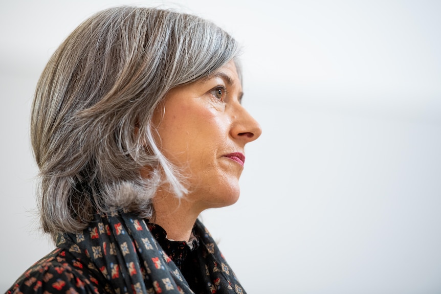 Side profile of a woman with short greying hair