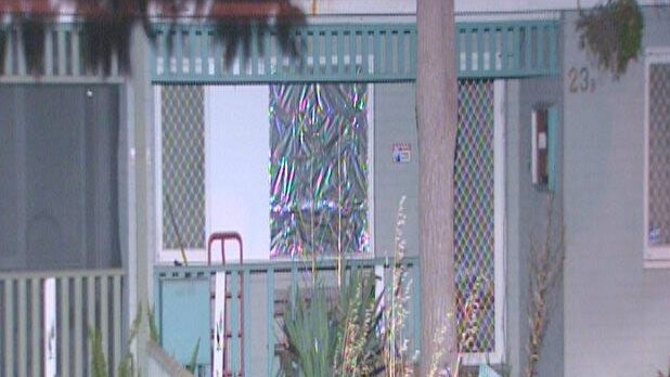 Front of a house with a window covered n tin foil.