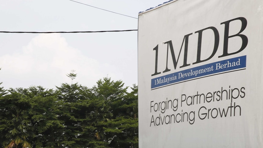 Traffic passes a 1Malaysia Development Berhad (1MDB) billboard at the Tun Razak Exchange development in Kuala Lumpur, Malaysia, July 6, 2015