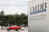 Traffic passes a 1Malaysia Development Berhad (1MDB) billboard at the Tun Razak Exchange development in Kuala Lumpur2
