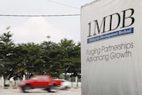 Traffic passes a 1Malaysia Development Berhad (1MDB) billboard at the Tun Razak Exchange development in Kuala Lumpur, Malaysia, July 6, 2015