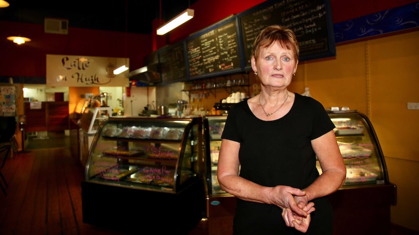 Bev Carroll stands in front of the counter at Latte on High.