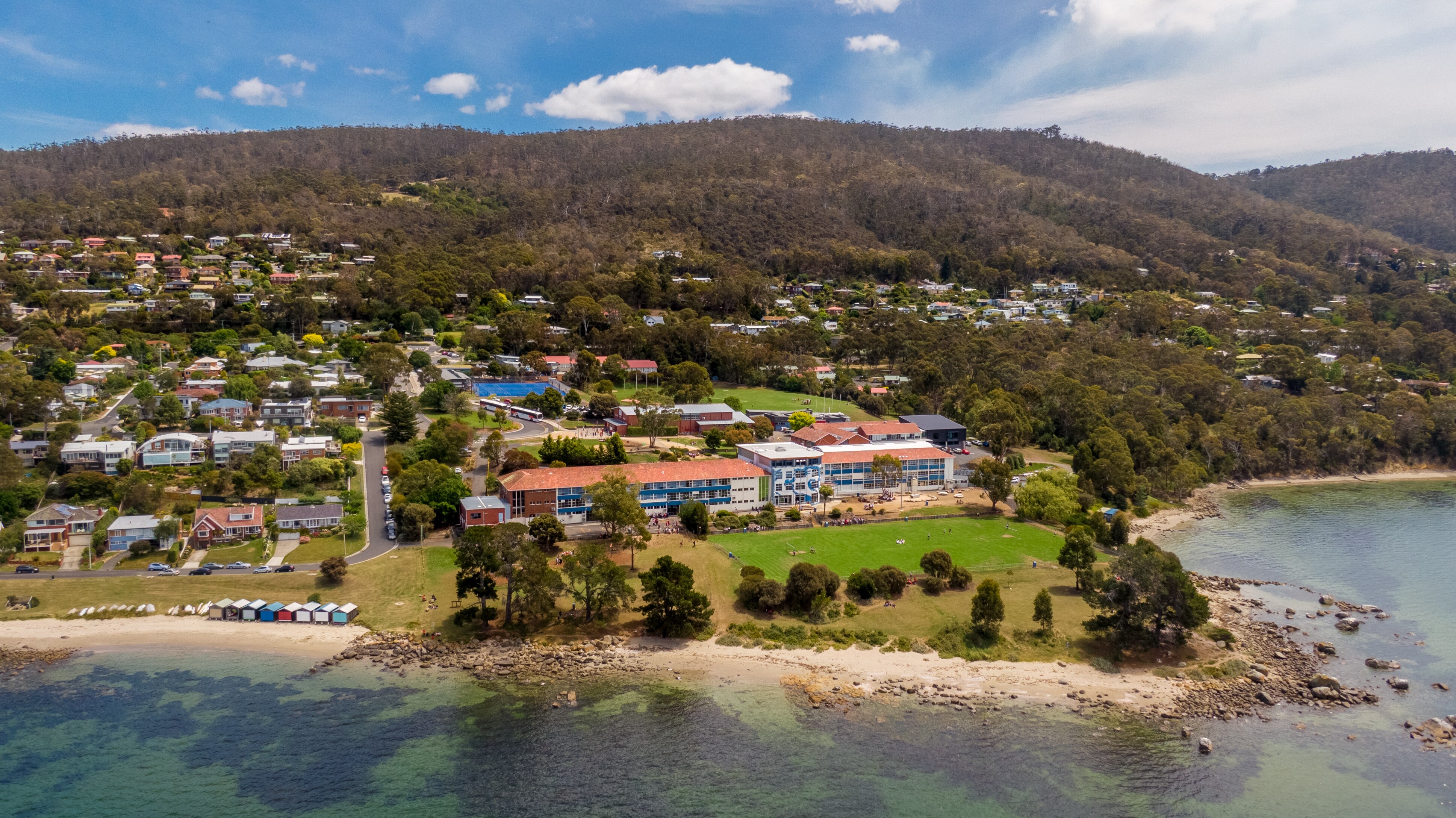 Drone photo of a high school by the sea.
