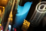 The Twitter logo appears on an updated phone post on the floor of the New York Stock Exchange.