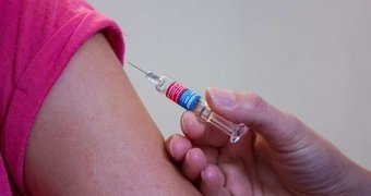 someone receiving a vaccine in their arm
