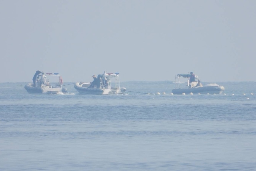 Chinese Coast Guard boats close to the floating barrie