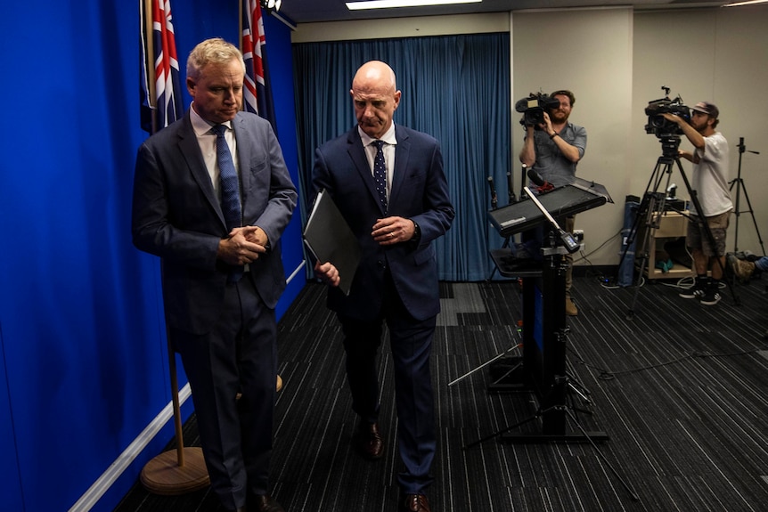 Peter Gutwein with Jeremy Rockliff walking towards camera.