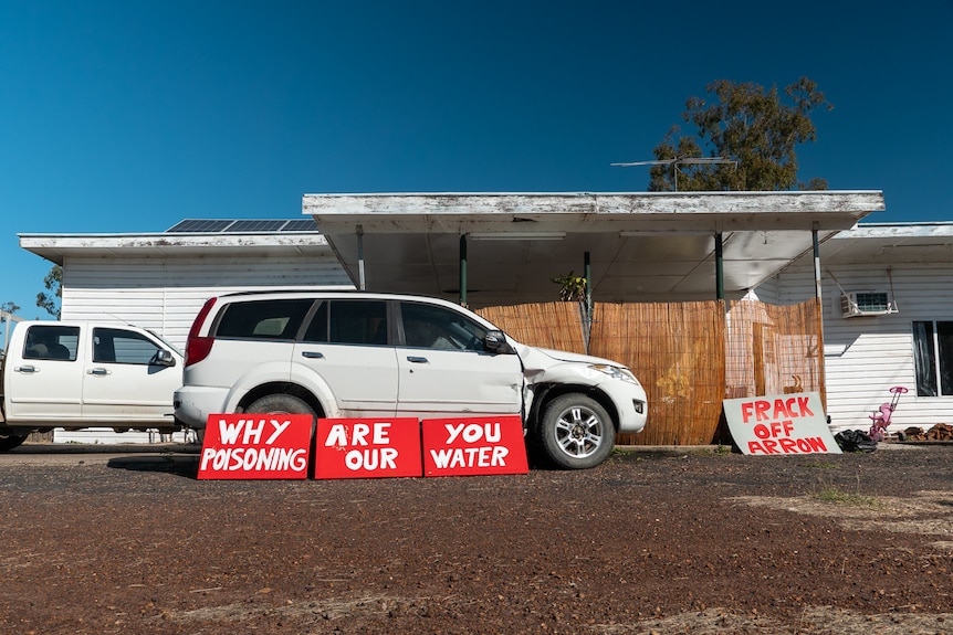 Red anti-CSG signage displayed outside a house