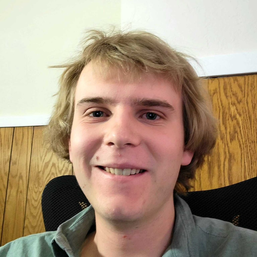 A smiling young man with blonde hair