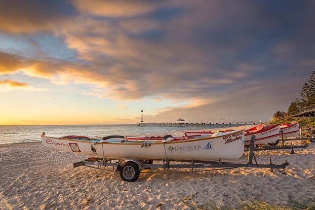 Surf boats on Brighton Beach, Melbourne, at sunset.