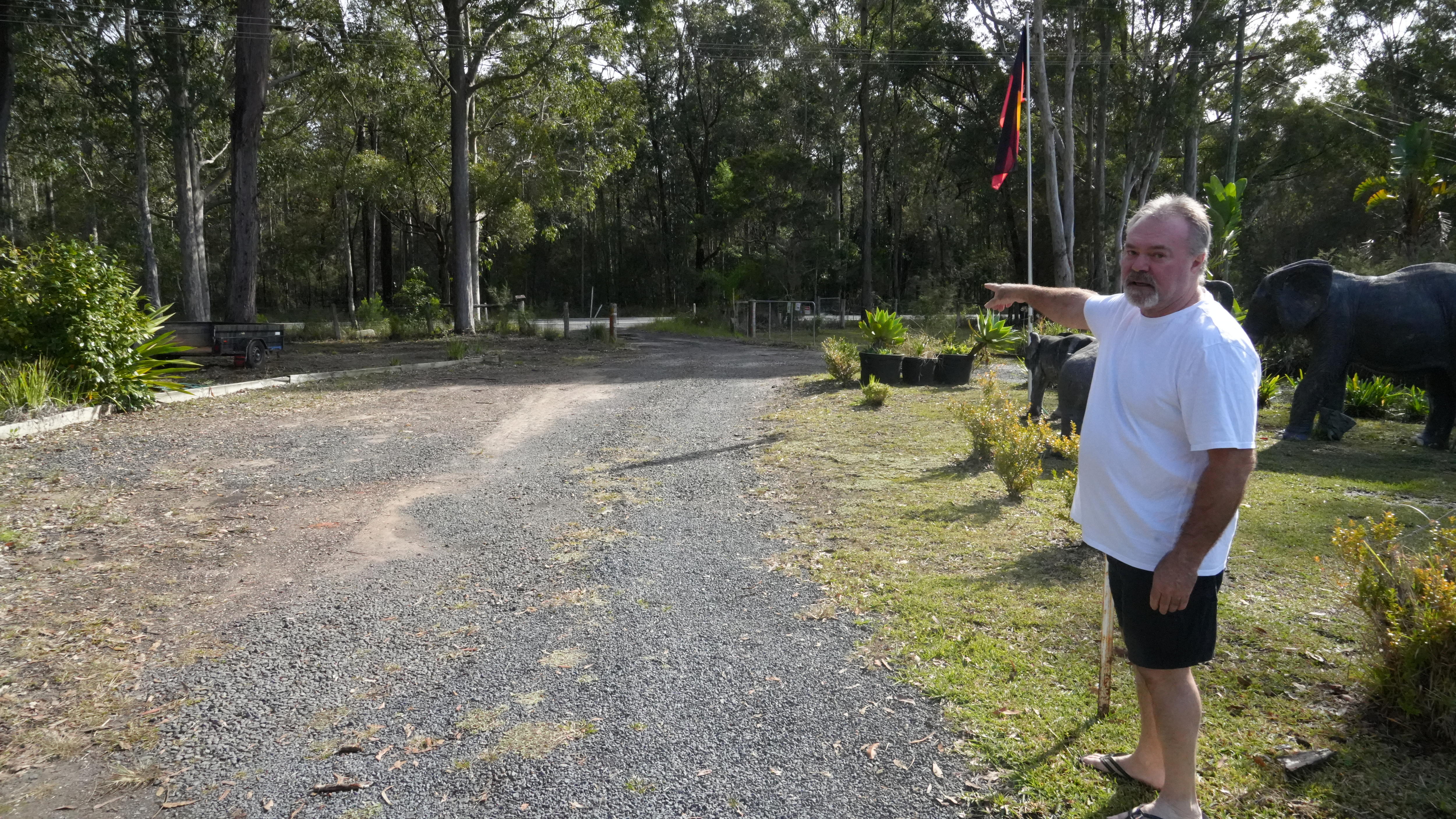 Man standing outside pointing.