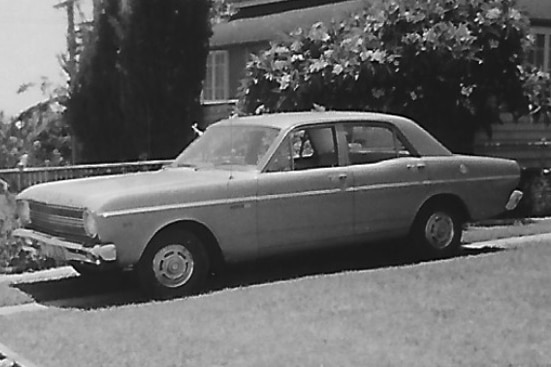 A black and white image of an old car